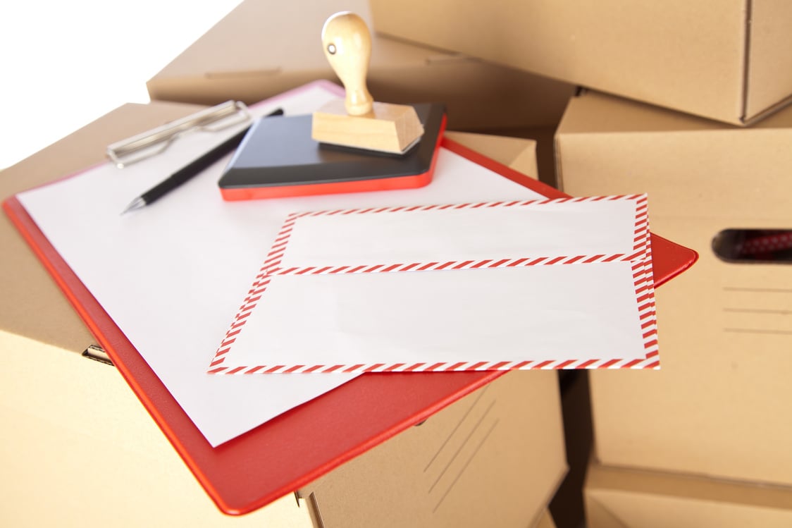 Mail Envelope on Cardboard Boxes